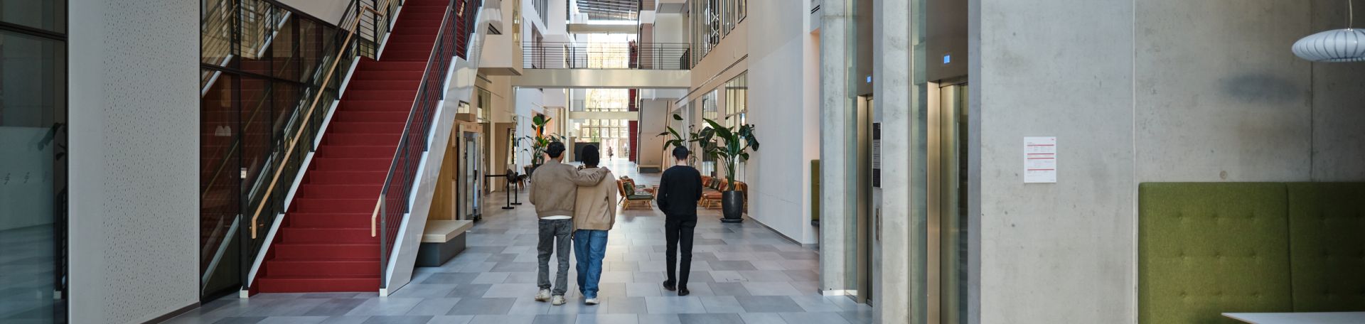 A section of the FS Mall on the ground floor is shown. People can be seen from behind walking together along the mall.